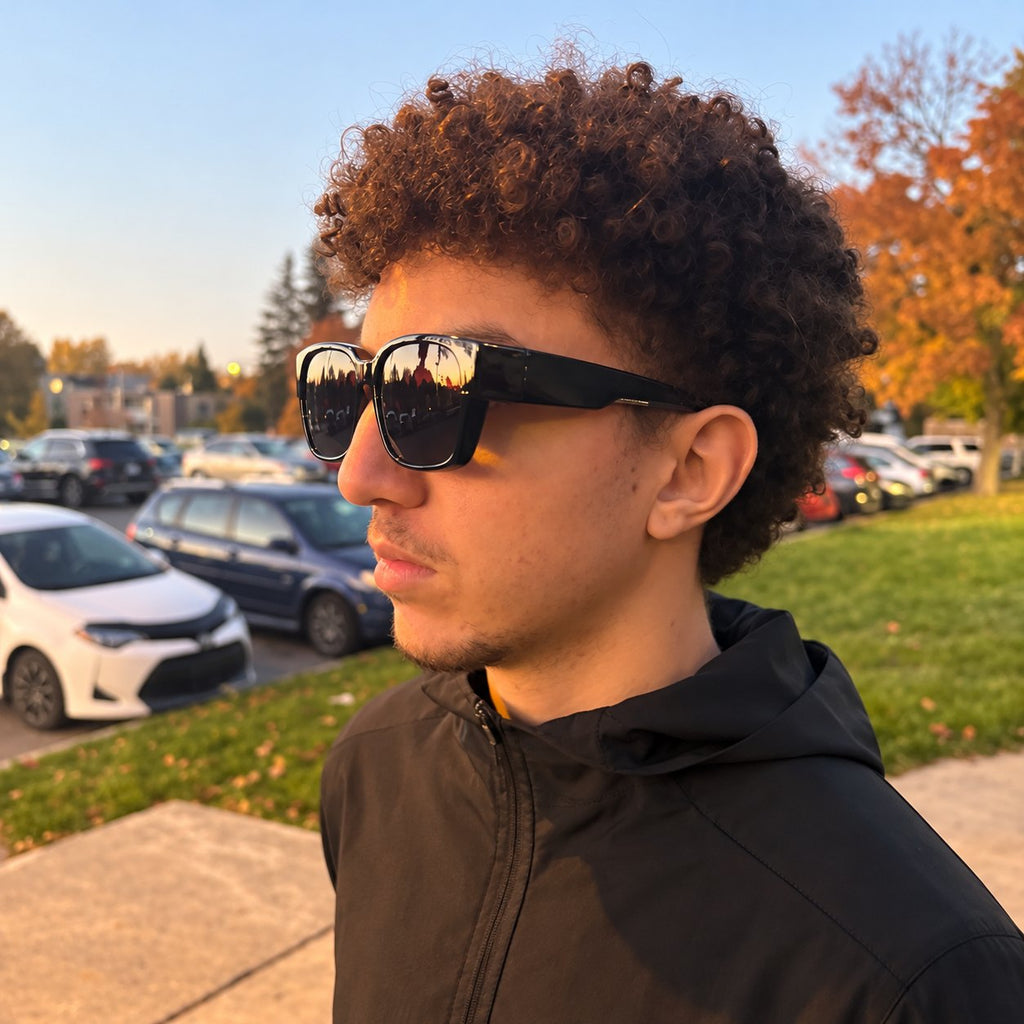 Man wearing NORDET smoke grey fit-over sunglasses outdoors in autumn