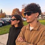 Couple outdoors in autumn wearing RAFALE smoke and AURORE fit-over sunglasses