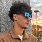 Man wearing SUROIT blue mirror fit-over shield sunglasses at sunset